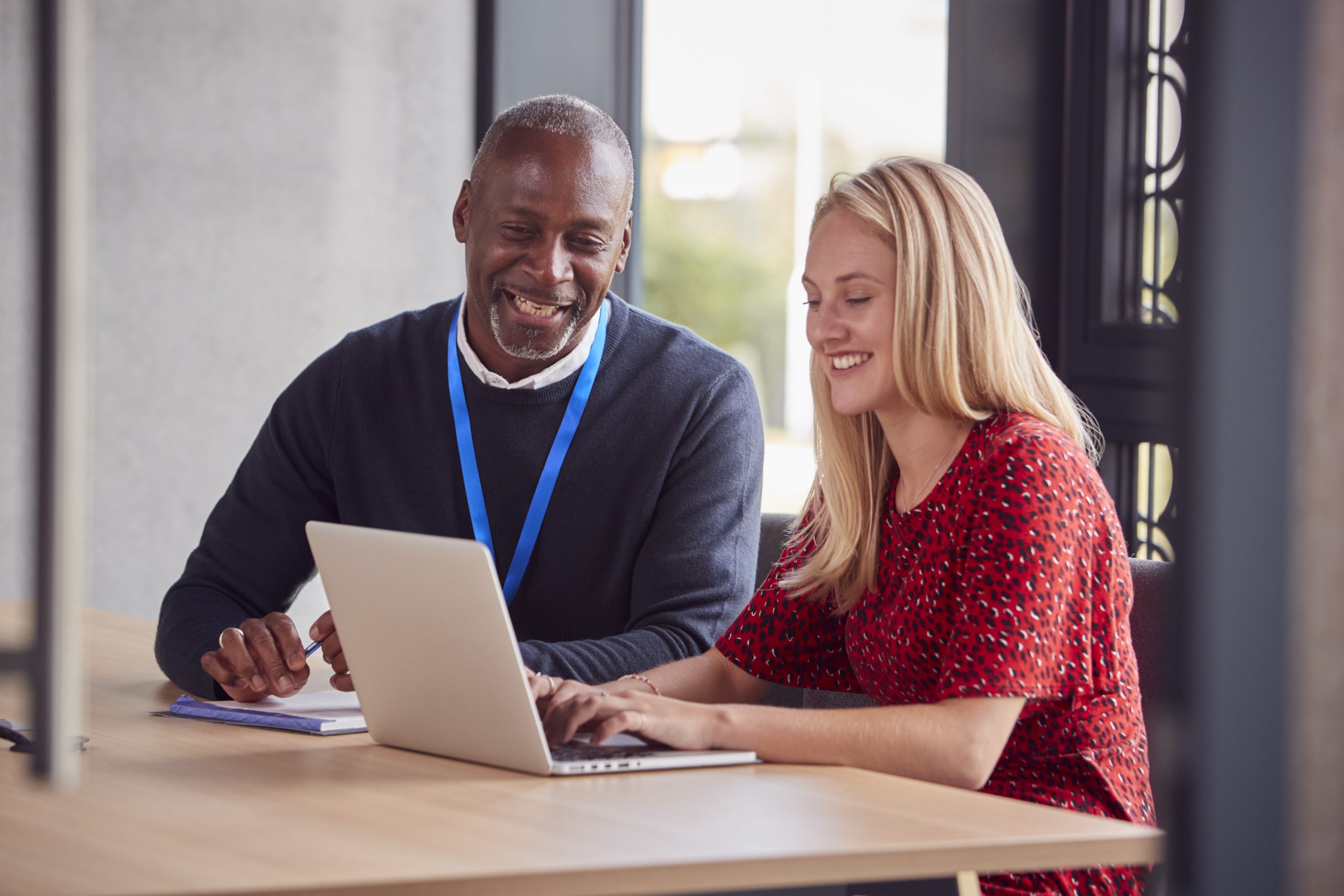 Female Employee With Laptop Having Individual Meeting With Boss